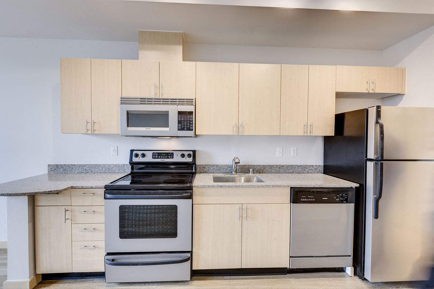 a kitchen with stainless steel appliances and white cabinets